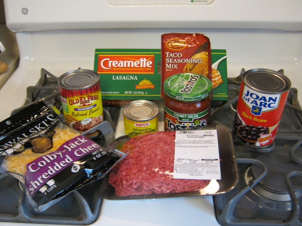 Taco seasoning, ground beef, refried beans, black beans, Colby jack cheese, peppers